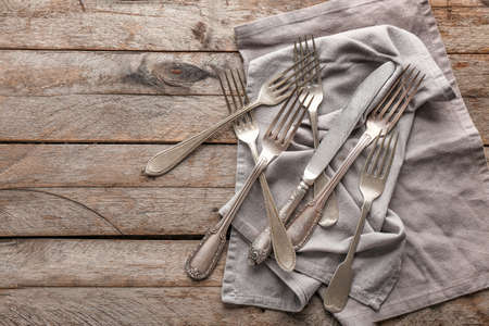 Silver cutlery on wooden backgroundの写真素材