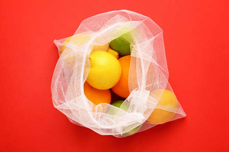Eco bag with fruits on color backgroundの写真素材