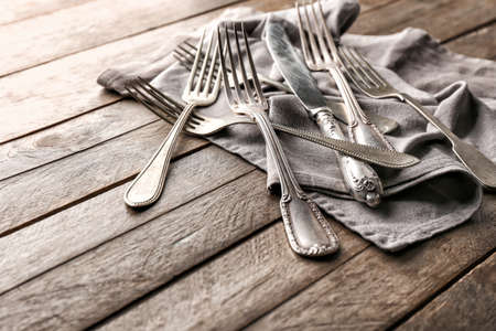 Silver cutlery on wooden backgroundの写真素材