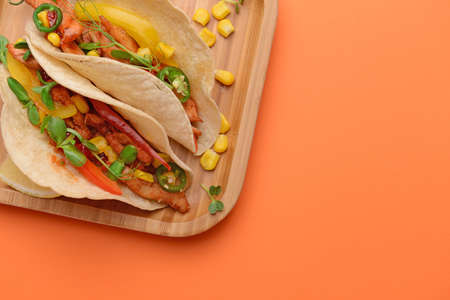 Plate with tasty fresh tacos on color backgroundの写真素材
