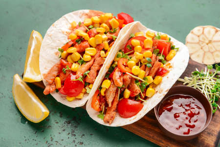Board with tasty tacos on color backgroundの写真素材