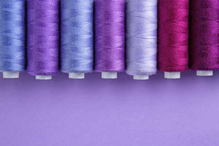 Many sewing threads on color backgroundの写真素材