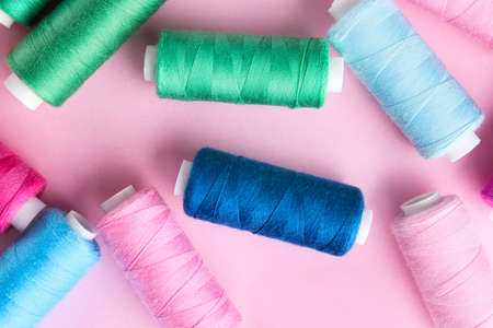 Many sewing threads on color background
