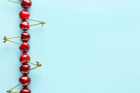 Sweet ripe cherry on color backgroundの写真素材