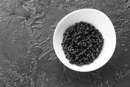 Plate with delicious black caviar on dark backgroundの写真素材