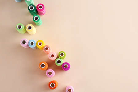 Many sewing threads on color background