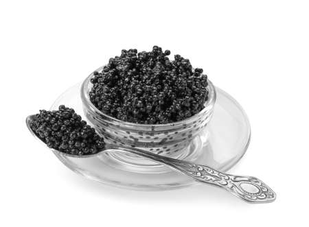 Bowl and spoon with delicious black caviar on white backgroundの写真素材
