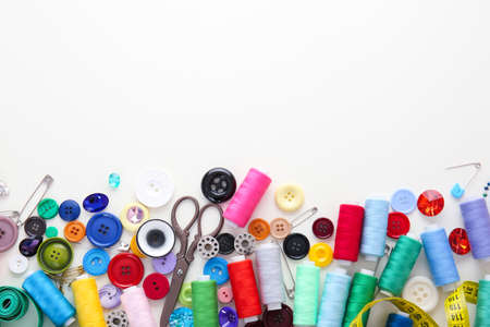 Set of sewing threads and accessories on white background