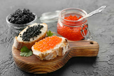 Sandwiches with delicious caviar on dark backgroundの写真素材