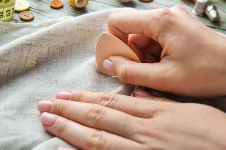 Female tailor with fabric and chalk, closeupの写真素材