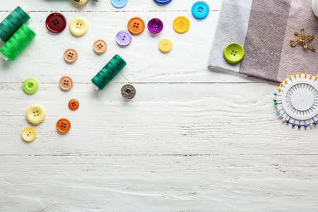 Set of sewing threads and accessories on white wooden backgroundの写真素材