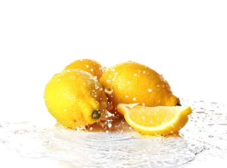Ripe lemons with water splash on white backgroundの写真素材