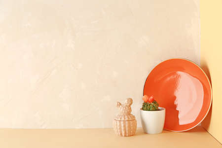 Plate with cactus in pot on tableの写真素材