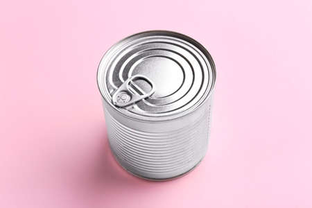 Tin can with food on color background