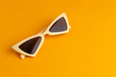 Modern sunglasses on color backgroundの写真素材