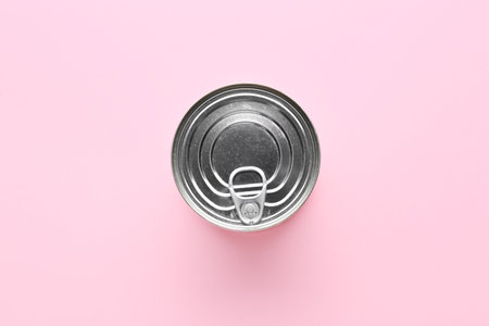 Tin can with food on color background