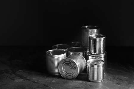Tin cans with food on dark backgroundの写真素材