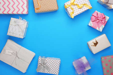 Frame made of beautiful gift boxes on color backgroundの写真素材
