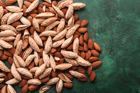 Many almonds on color background