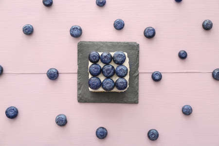 Tasty mousse cake with blueberry on color wooden backgroundの写真素材