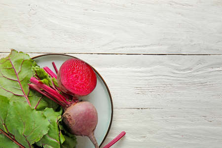 Plate with fresh beet on white table
