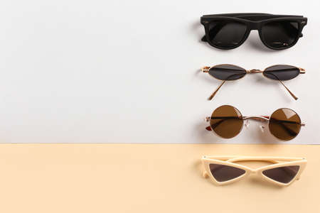 Different modern sunglasses on color backgroundの写真素材