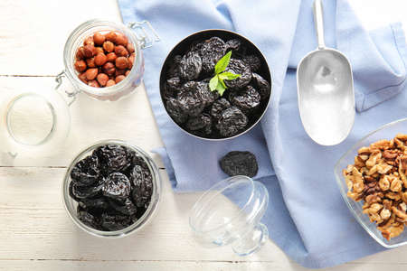 Tasty prunes with different nuts on tableの写真素材