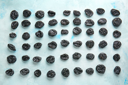 Tasty prunes on color background