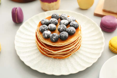 Plate with tasty blueberry pancakes on gray backgroundの写真素材