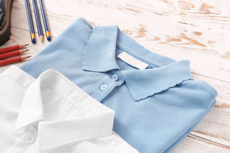 School uniform and stationery on wooden backgroundの写真素材