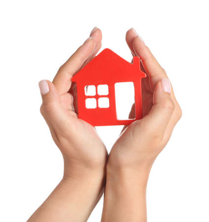 Female hands with figure of house on white background. Mortgage conceptの写真素材