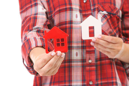 Woman with figures of houses, closeup. Mortgage concept