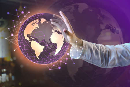 Businessman with digital model of Earth on dark background