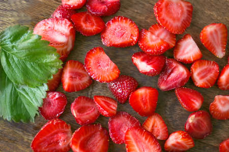 Sliced ripe strawberry on wooden backgroundの写真素材