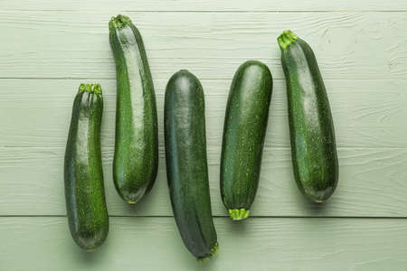 Fresh zucchini squashes on wooden backgroundの写真素材