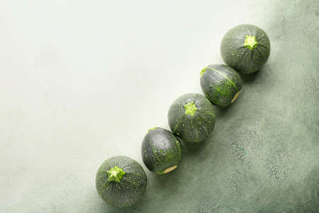 Fresh zucchini squashes on color backgroundの写真素材