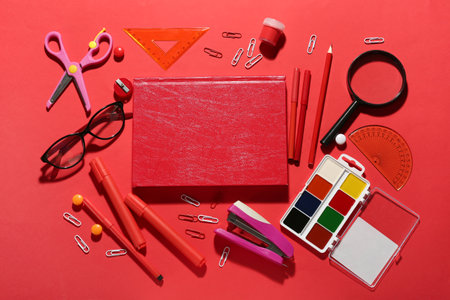 Different school stationery on color background
