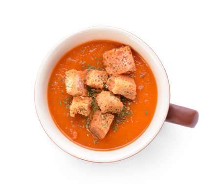 Cup of tasty tomato cream soup on white background