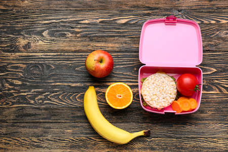 Lunch box with tasty food on wooden backgroundの写真素材