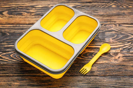 Plastic lunch box on wooden background