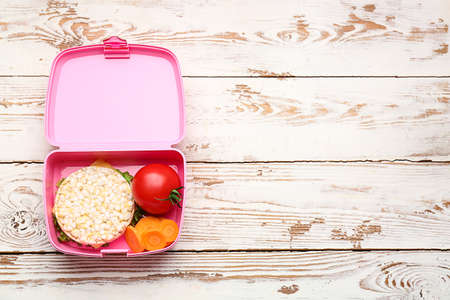 Lunch box with tasty food on wooden backgroundの写真素材