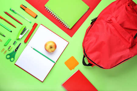 School backpack and stationery on color backgroundの写真素材