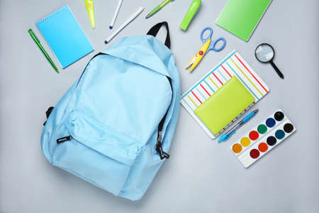 School backpack and stationery on light backgroundの写真素材