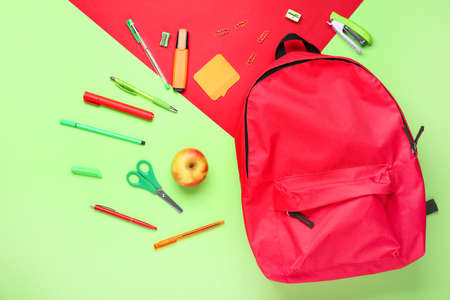 School backpack and stationery on color backgroundの写真素材