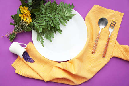 Beautiful table setting with floral decor on color backgroundの写真素材