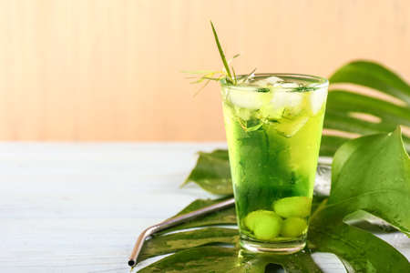 Glass of tasty summer cocktail on tableの写真素材