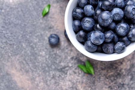 Bowl with ripe blueberry on gray backgroundの写真素材