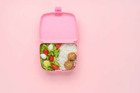 School lunch box with tasty food on color background