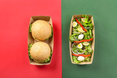 Containers with delicious food on color backgroundの写真素材