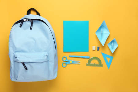 Backpack with school supplies on color backgroundの写真素材